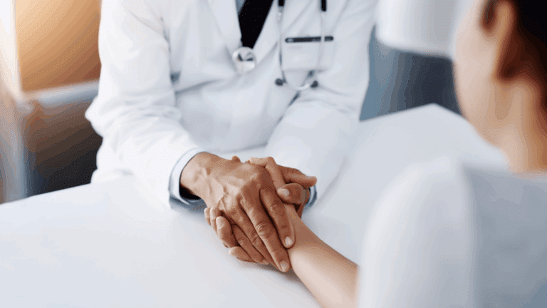A doctor offering support for a sensitive mold-sick patient, holding hands over the medical exam table.
